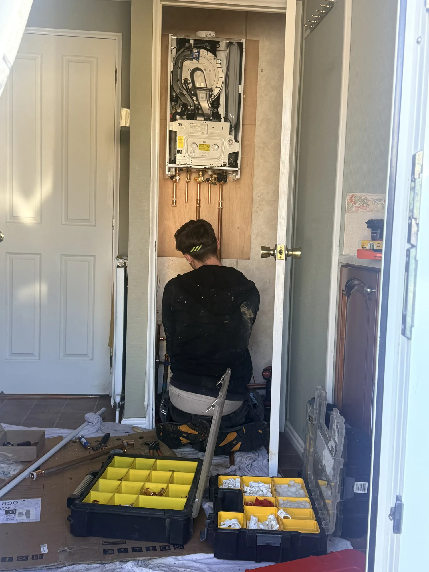 Boiler installation in progress in a Kent hallway